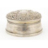 Circular silver jewel box by WI Broadway & Co, the hinged lid embossed with birds amongst flowers,