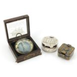 Three military interest compasses including one with case, the largest 8cm in diameter :For