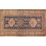 Rectangular Persian rug, the central field having three medallions onto a blue ground, 190cm x 114cm