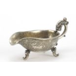 Chinese silver coloured metal sauce boat, decorated with mythical beasts, character marks to the