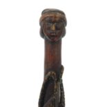 Tribal interest walking stick with figural pommel, carved with serpents, 92cm in length :For Further