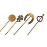 Four Victorian gold and yellow metal tie pins, some set with seed pearls and a horseshoe example,