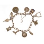 Silver charm bracelet with selection of mostly silver charms including typewriter, fire bellows