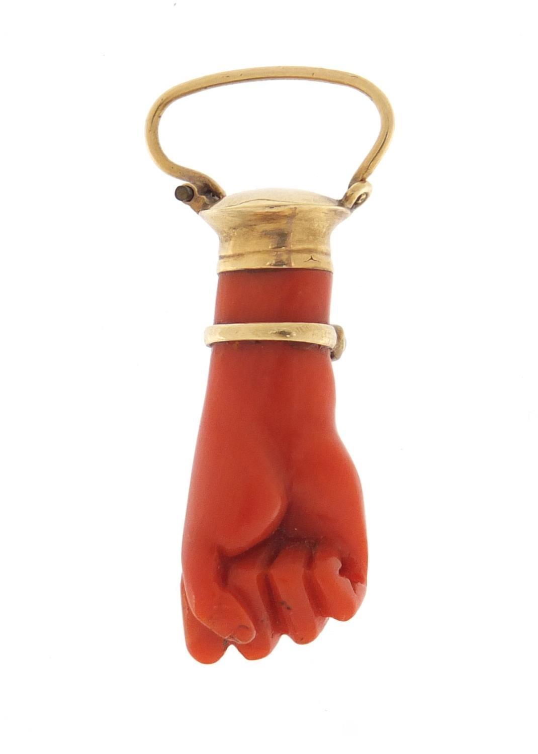 Victorian carved coral pendant in the form of a clutched hand with unmarked gold mounts and - Image 2 of 2