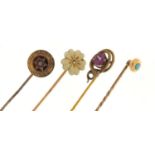 Four Victorian unmarked gold and gilt metal tie pins including a serpent and one set with a