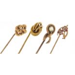 Three Victorian unmarked gold tie pins and one other enamelled with flowers, the largest 7cm in