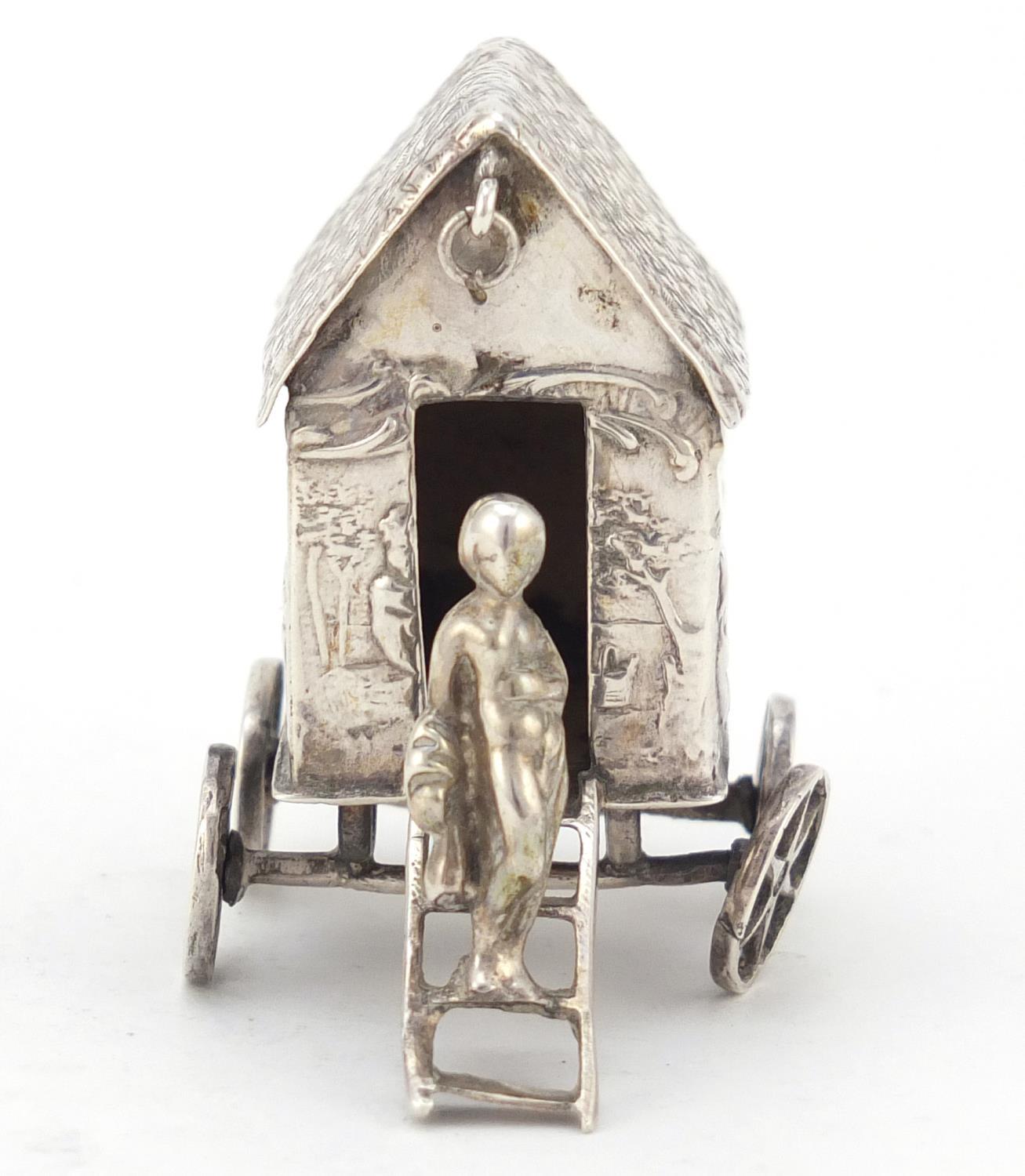 Victorian silver model of a young figure on a wagon, embossed with Putti playing, indistinct