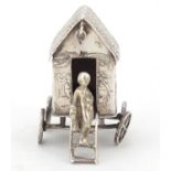 Victorian silver model of a young figure on a wagon, embossed with Putti playing, indistinct