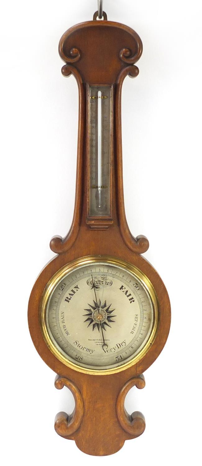 Negretti & Zambra oak wall barometer with thermometer with silvered dials, numbered 19143, 82cm high