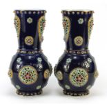 Large pair of continental porcelain vases with reticulated roundels, hand painted with flowers,