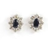 Pair of unmarked gold black and clear stone flower head earrings, 1cm high, 1.2g :For Further