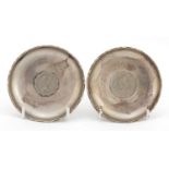 Pair of circular sterling silver Hong Kong dollar coin dishes, by Wai Kee, 8.5cm in diameter, 84.