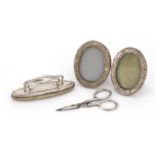 Pair of miniature silver easel photo frames, silver handled buffer and scissors, various