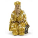 Chinese porcelain figure of seated Emperor holding a scroll, hand painted with Daoist emblems,