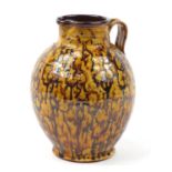 Studio pottery jug by David Heminsley having a brown dripping glaze, impressed marks around the foot