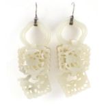 Pair of Chinese pale green jade drop earrings with silver coloured mounts, each pierced and carved