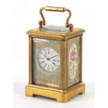Miniature brass cased carriage clock with porcelain panels, hand painted and gilded with flowers,