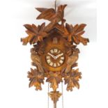 German Black forest style cuckoo clock carved with birds, label to the reverse, 39.5cm high :For