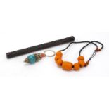 Miscellaneous objects including a Chinese parasol handle and amber style beads, the largest 23cm