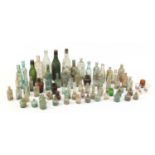 Collection of antique glass advertising bottles including Clince & Co, the largest 27.5cm high :