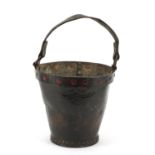 Antique leather fire bucket with metal rim and remnants of paint, 27cm high excluding the handle :