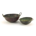 Two heavy Middle Eastern cooking bowls including a bronze example, the largest 34cm in diameter :For