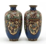 Pair of Japanese cloisonné vases enamelled with panels of birds of paradise and dragons, each 18.5cm