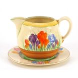 Art Deco Clarice Cliff pottery jug hand painted in the crocus pattern and a similar plate, the jug