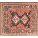 Rectangular Persian rug with two central medallions, onto black, red and blue grounds, 145cm x 125cm