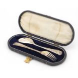 Continental silver christening fork and spoon, housed in a velvet and silk lined leather case, the