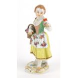 19th century Meissen porcelain figurine of a girl holding a basket of flowers, blue cross sword