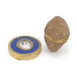 Circular gilt and enamel compact hand painted with a female and an agate cave trinket, the largest