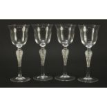 Set of four Faberge glasses with frosted glass figural stems, each 20.5cm high :For Further