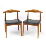 Pair of Danish design hardwood cow horn design chairs in the style of Hans Wegner, each 75cm high :