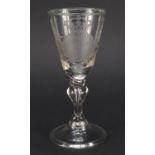 17th/18th century wine glass engraved with a coat of arms, having a baluster stem enclosing a tear