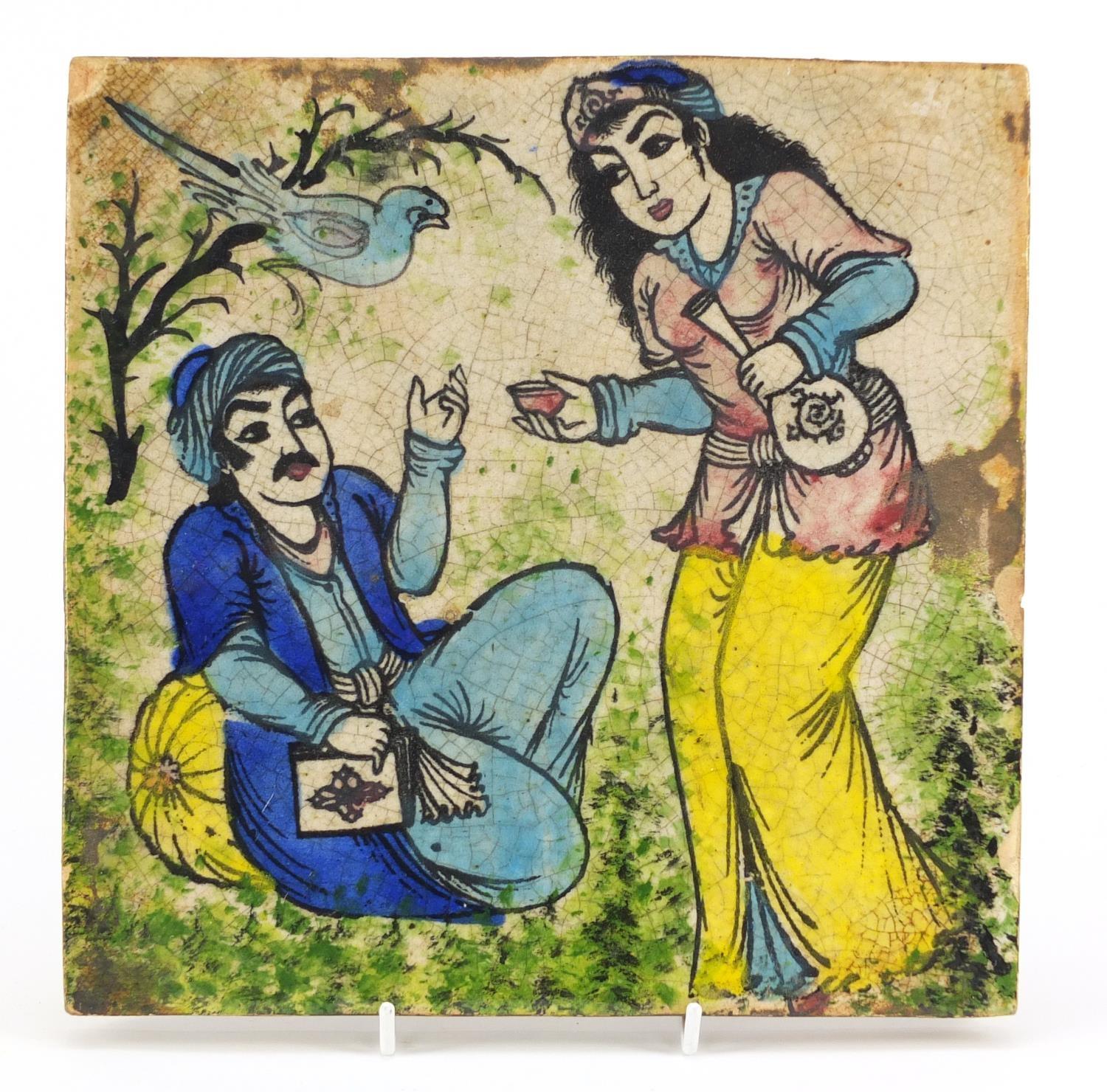 Islamic pottery tile hand painted with two figures and a bird, 24.5cm X 24.5cm : For Condition