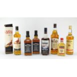 Seven bottles of whiskey and rum including 1L Bells, two bottles of Jack Daniels, The Famous