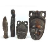 Four wood carvings including two tribal face masks, the largest 49.5cm high : For Condition