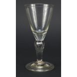 Early 18th century baluster wine glass with trumpet bowl and teared inverted folded foot,