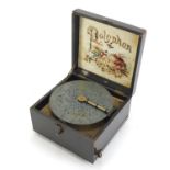 Wooden cased 6 inch polyphone music box with fifteen discs, the top with hand painted floral