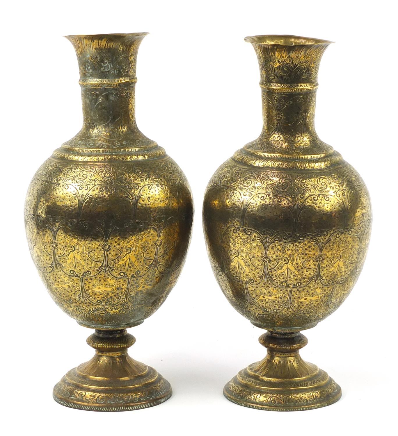 Large pair of Indian brass vases engraved with figures, animals and flowers, each 53cm high : For