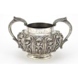 Indian unmarked silver twin handled sugar bowl, embossed with mythical figures, 14cm wide, 245.