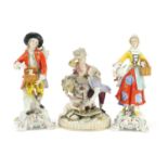 Three continental hand painted porcelain figures including a Meissen style group of two lovers and