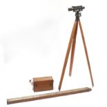 Surveyor's instruments comprising a Stanley theodolite on stand and a measuring stick by Holborn