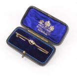 Unmarked gold diamond three stone bar brooch housed in a JW Benson velvet and silk lined box, 5.
