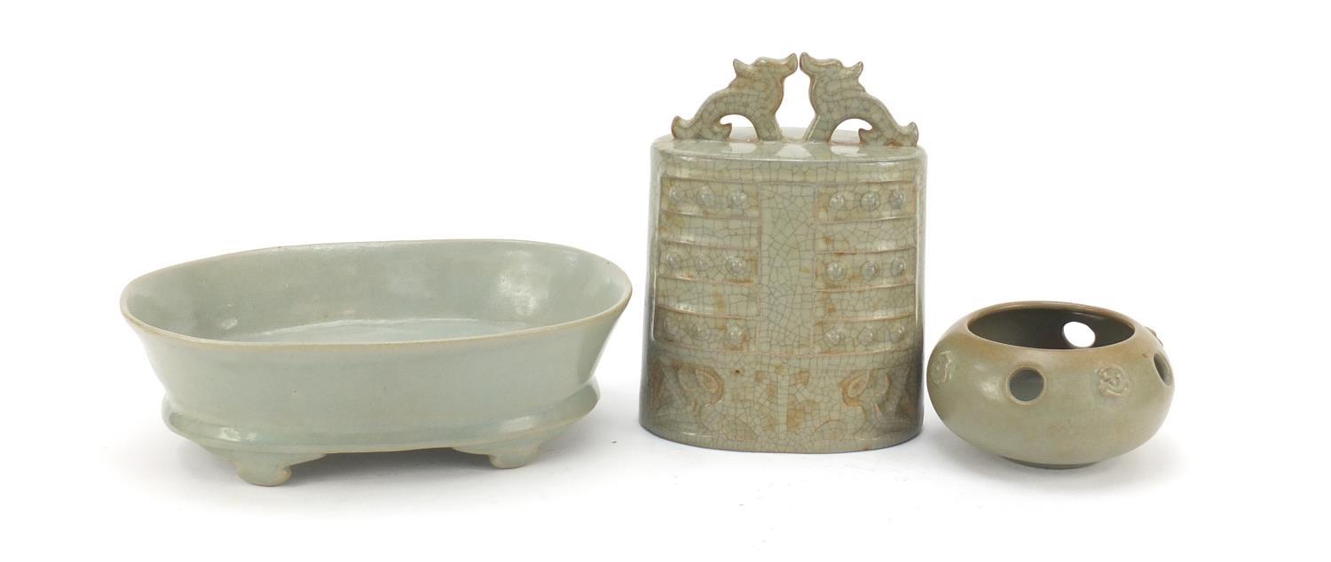 Korean celadon pottery including an archaic style bell and four footed dish, the largest 22cm wide :