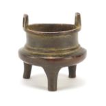 Miniature Chinese patinated bronze tripod incense burner, character marks to the base, 5.5cm