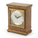 Carved oak Elliott mantle clock with silvered face having gilt spandrels retailed by G H