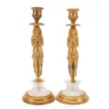 Pair of French Empire style Egyptian revival gilt bronze and rock crystal candlesticks, each 25cm