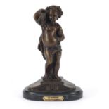 Patinated bronze figure carrying wheat, titled La Misson, raised on an oval black marble base,